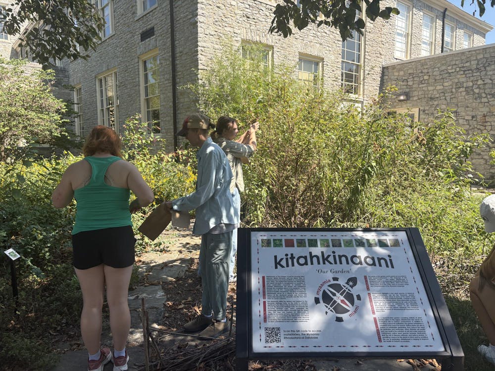 Sarah Dumyahn and students gather herbs from the Kitahkinaani garden. 