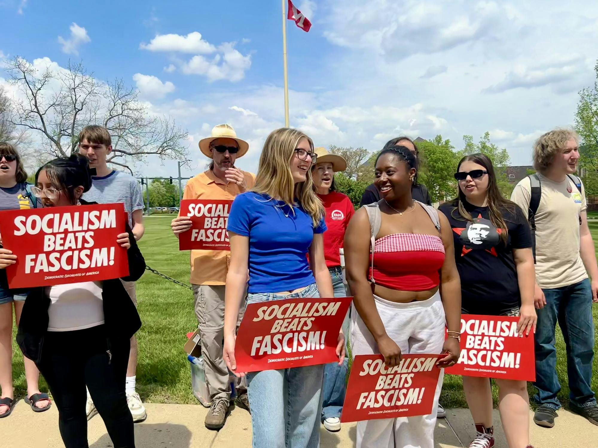 Members of the YDSA hold signs during their protest