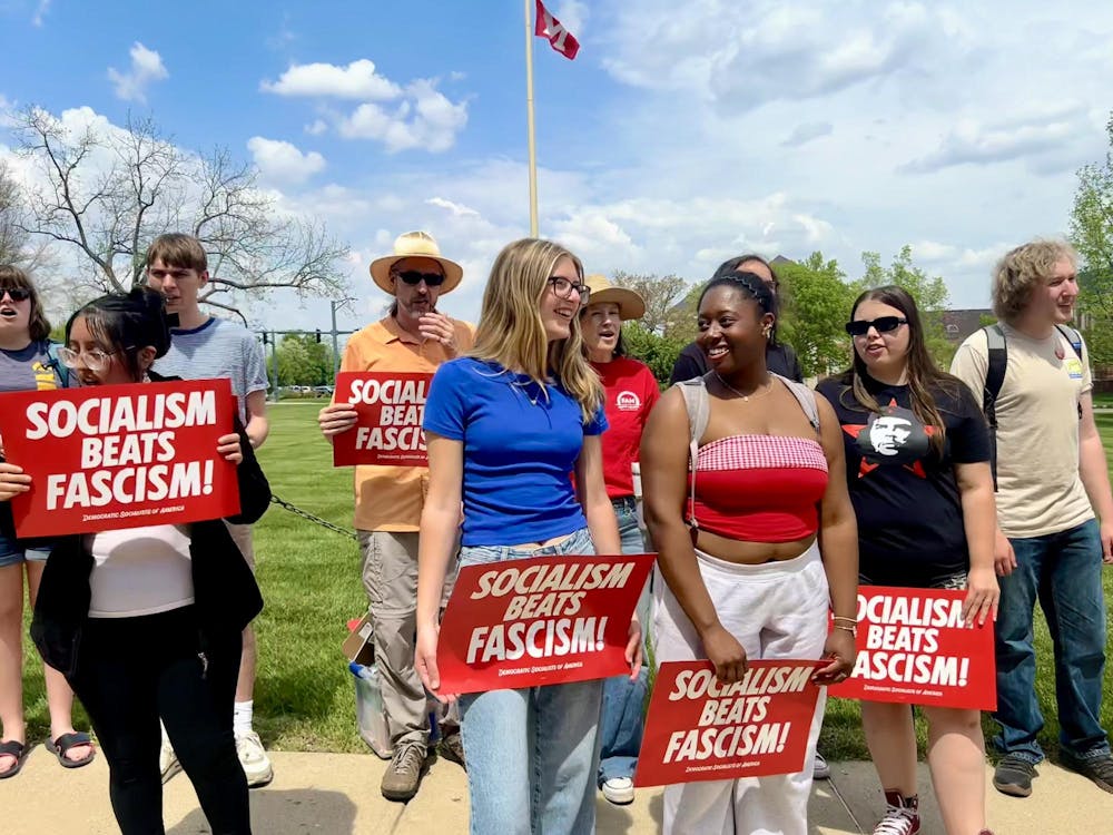 Members of the YDSA hold signs during their protest