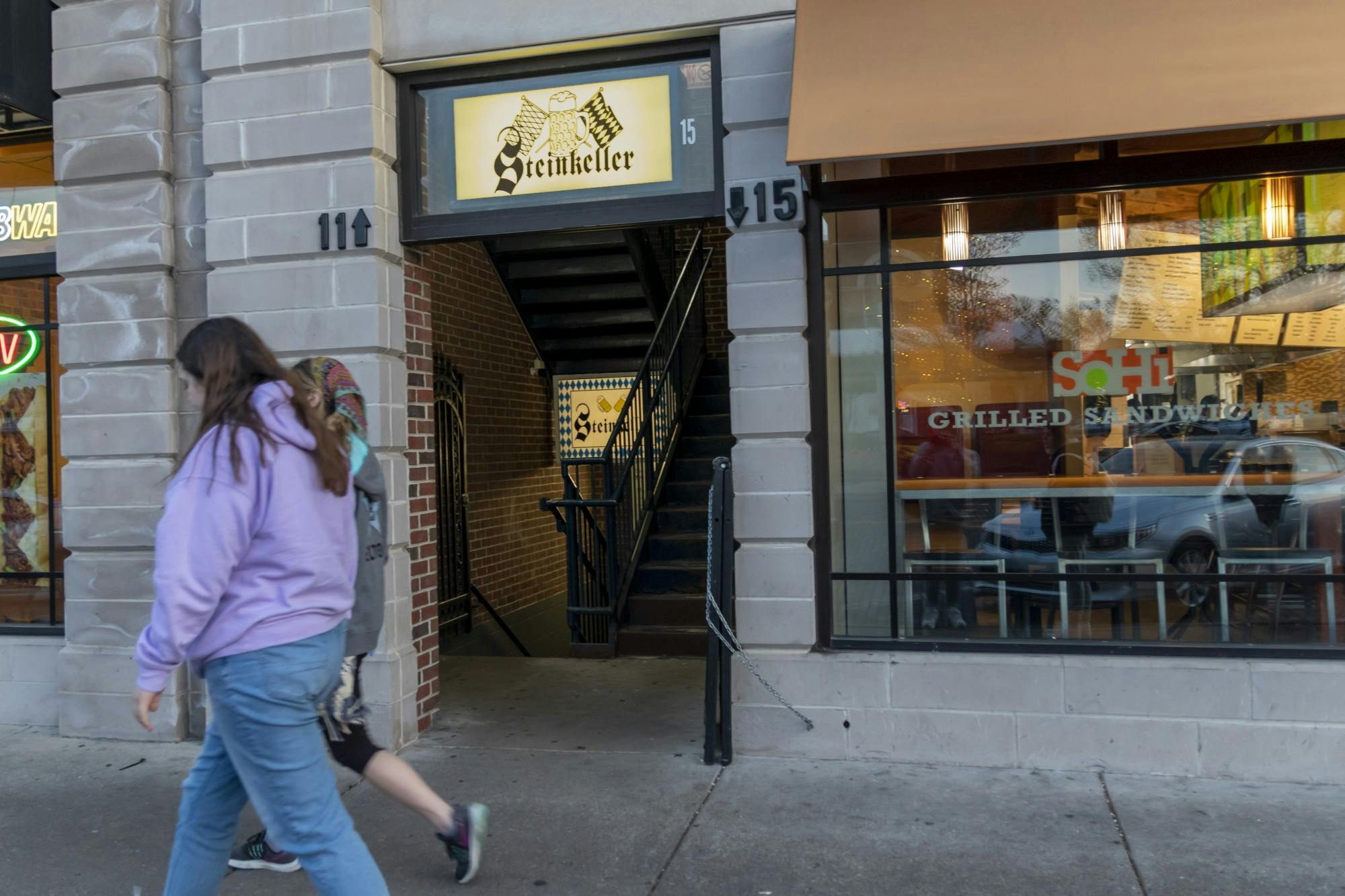 Students pass by the entrance to Steinkeller on High Street, which is half-hidden between SoHi and Subway.
