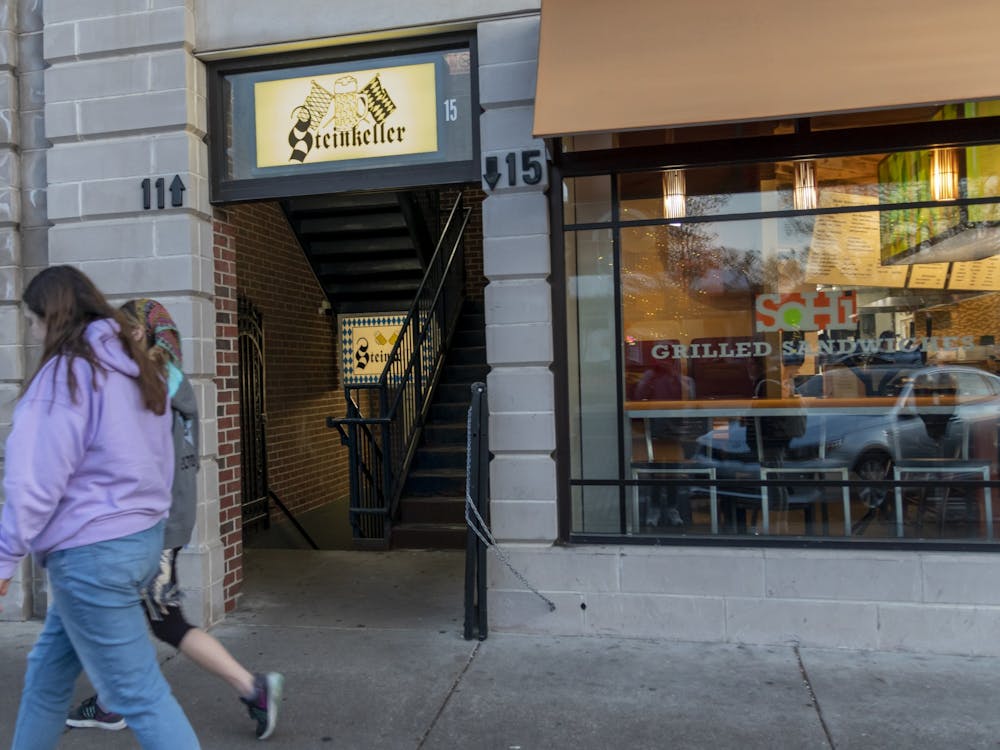 Students pass by the entrance to Steinkeller on High Street, which is half-hidden between SoHi and Subway.