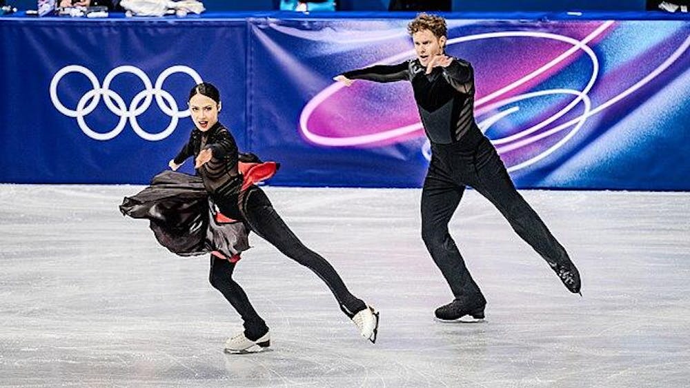 Madison Chock (left) and Evan Bates (right) skate at the Winter Olympics in Milano Cortina