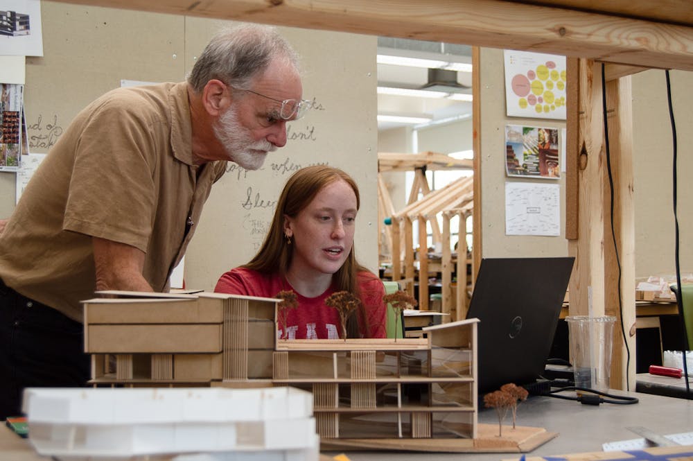 Professor Elliott working one-on-one with a student. 