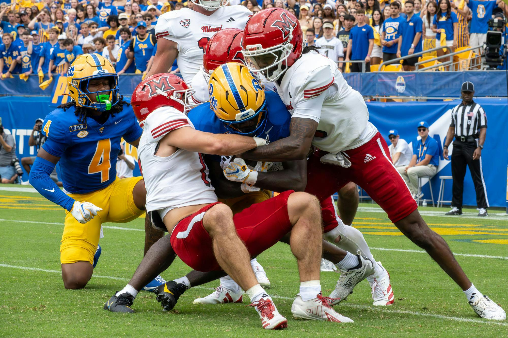 Defense tackles a player in the game against Pitt.