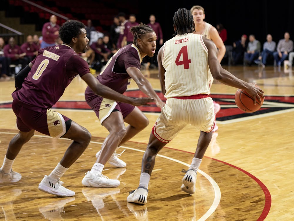 Senior guard Darweshi Hunter handles against a double-team late in the second half against Texas State. Hunter led all scorers with 21 in the RedHawks' home opening loss on Saturday.