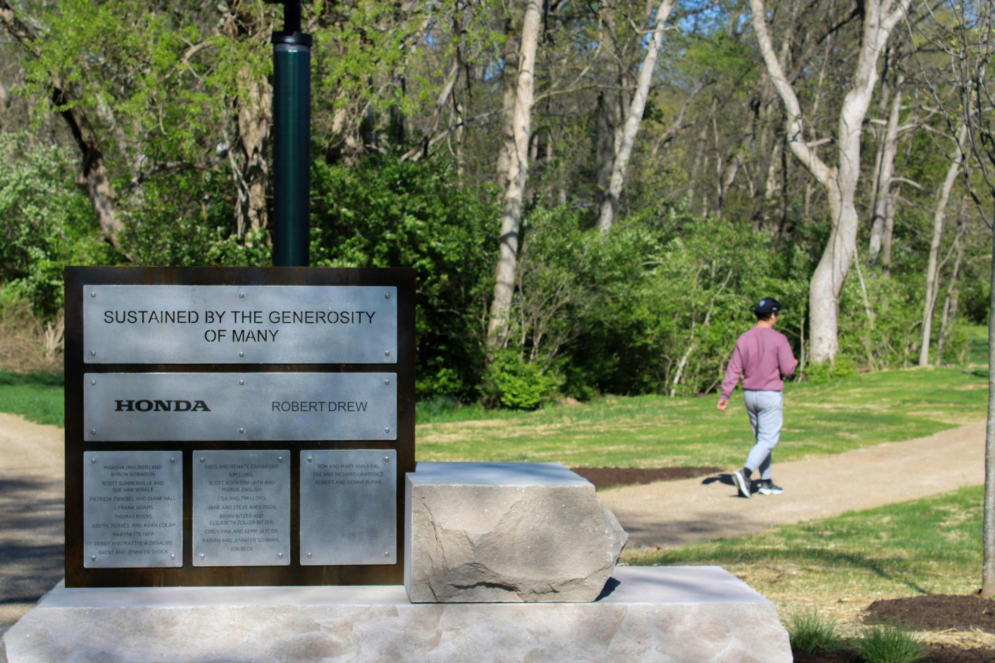 Miami student taking a walk on the trails of Sharon and Mitchell Graham Sustainability Park.