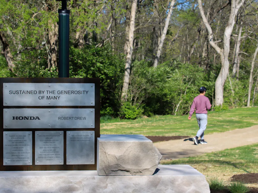 Miami student taking a walk on the trails of Sharon and Mitchell Graham Sustainability Park.