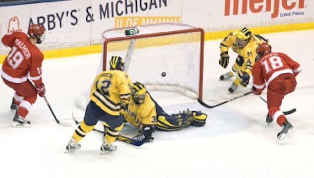 Freshman forward Reilly Smith nets a puck against the University of Michigan on Nov. 7, 2009.