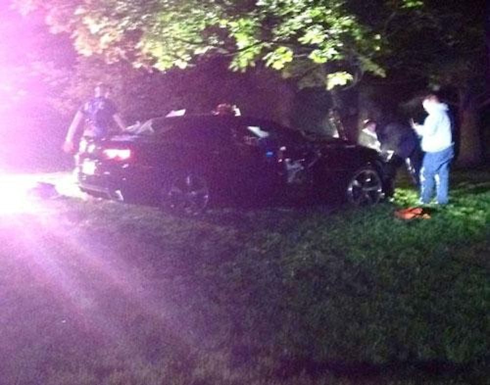 The Oxford Police Department and Oxford Fire Department work to stabilize the man inside the Camaro that crashed into a tree near Emerson Hall Saturday