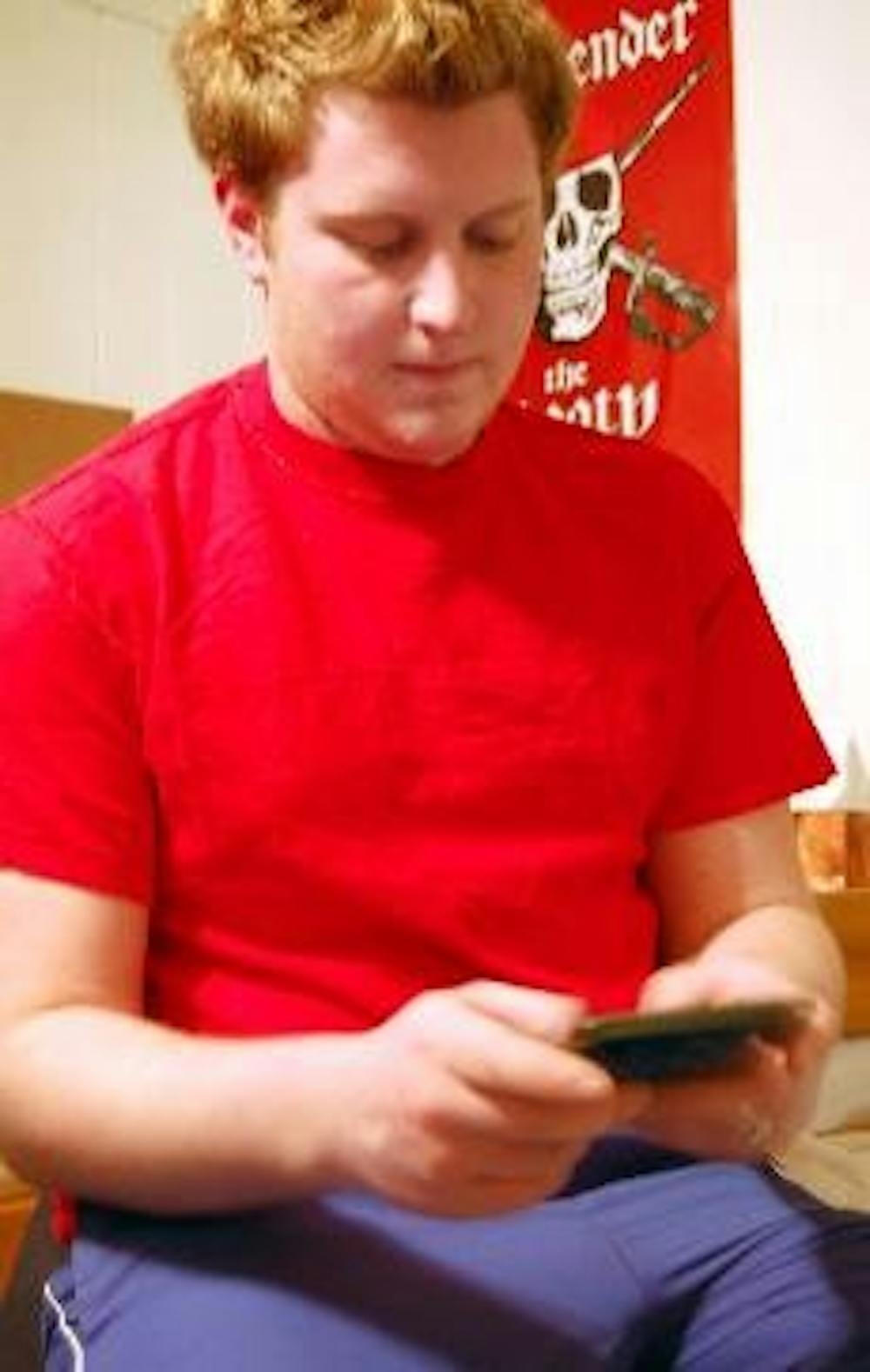 Sophomore BJ Jacobs checks for text messages in his residence hall. The emergency text messaging system, set to be tested Jan. 23, will be followed by a user survey.