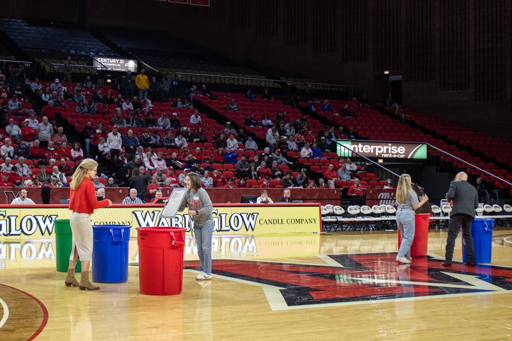 <p>President Gregory Crawford and his wife square off in a waste-sorting competition at half-time of the men&#x27;s basketball game on Feb. 11.</p>