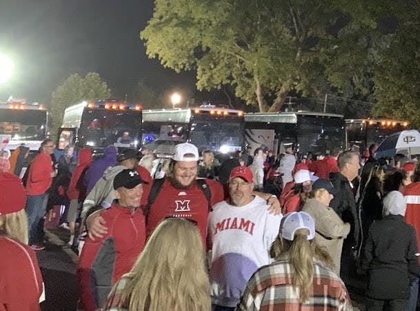 Miami fans celebrate in the rain outside Ryan Field after the RedHawks’ 17-14 upset over Northwestern.