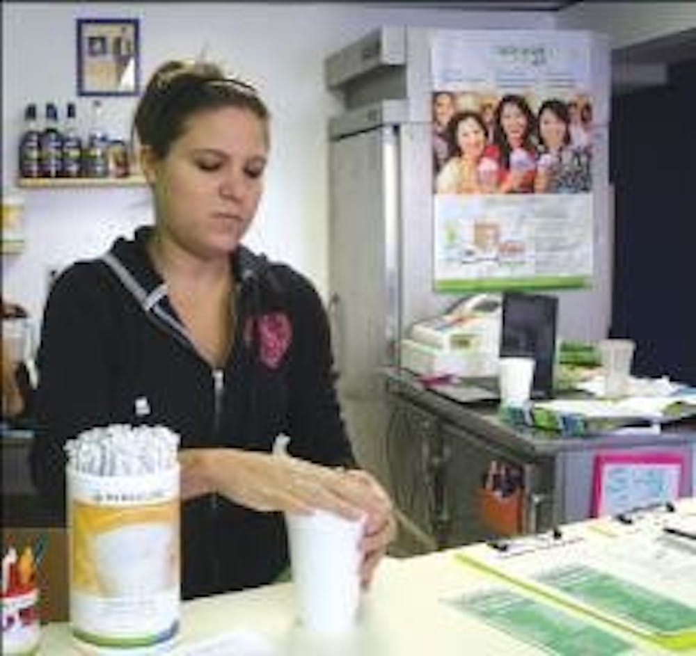 A High Street Health employee prepares a nutritional smoothie for customers. The store, located where Figleaf stood, opened Sept. 23.
