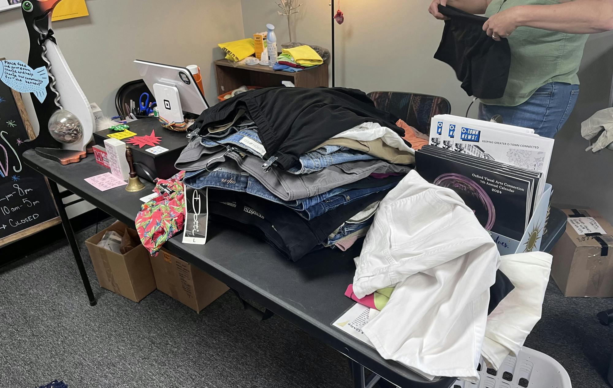 Unwanted summer clothing styles pile up in the back of ThreadUp Oxford, a local thrift store.
