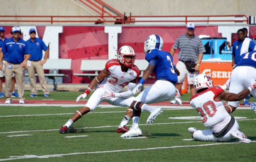 Heath Harding guards Presbyterian WR Tre'von Howell.