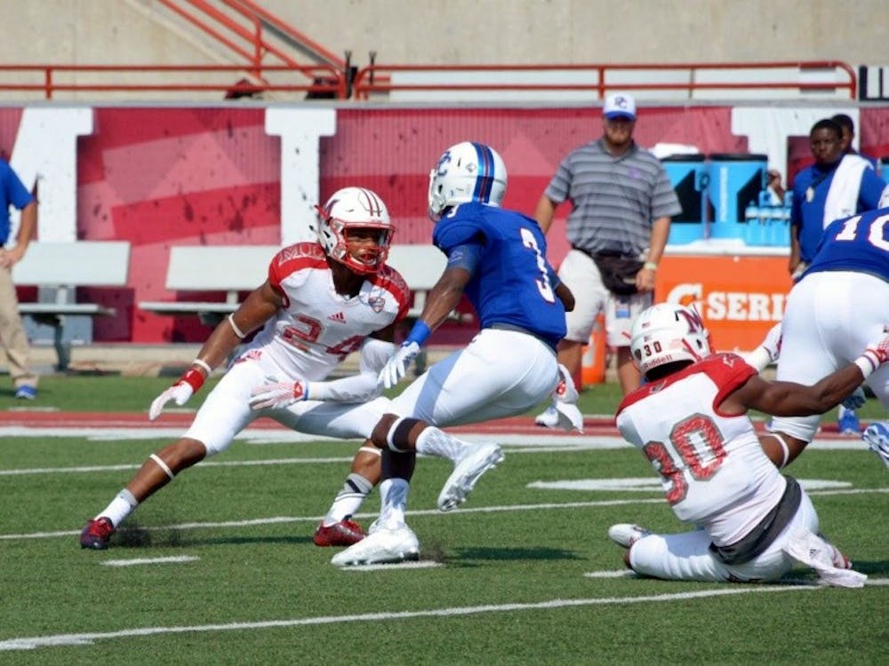 Heath Harding guards Presbyterian WR Tre'von Howell.