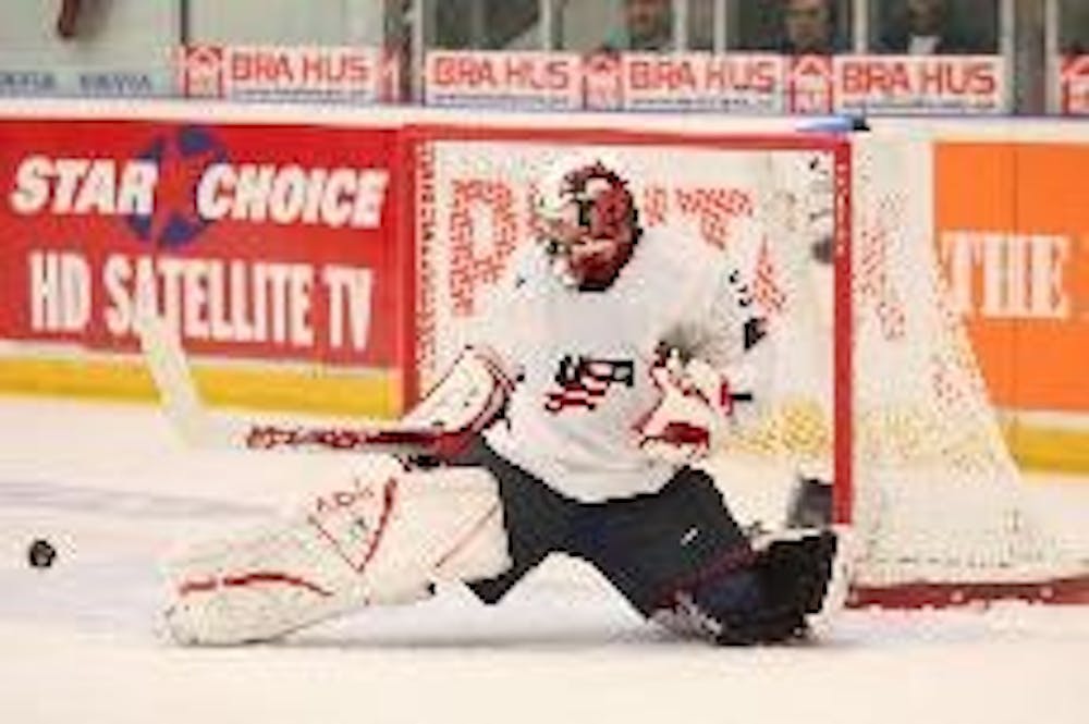 Miami goaltender Jeff Zatkoff deflects a shot while sporting the Red and White mask when representing the Red, White and Blue in Sweden during winter break.