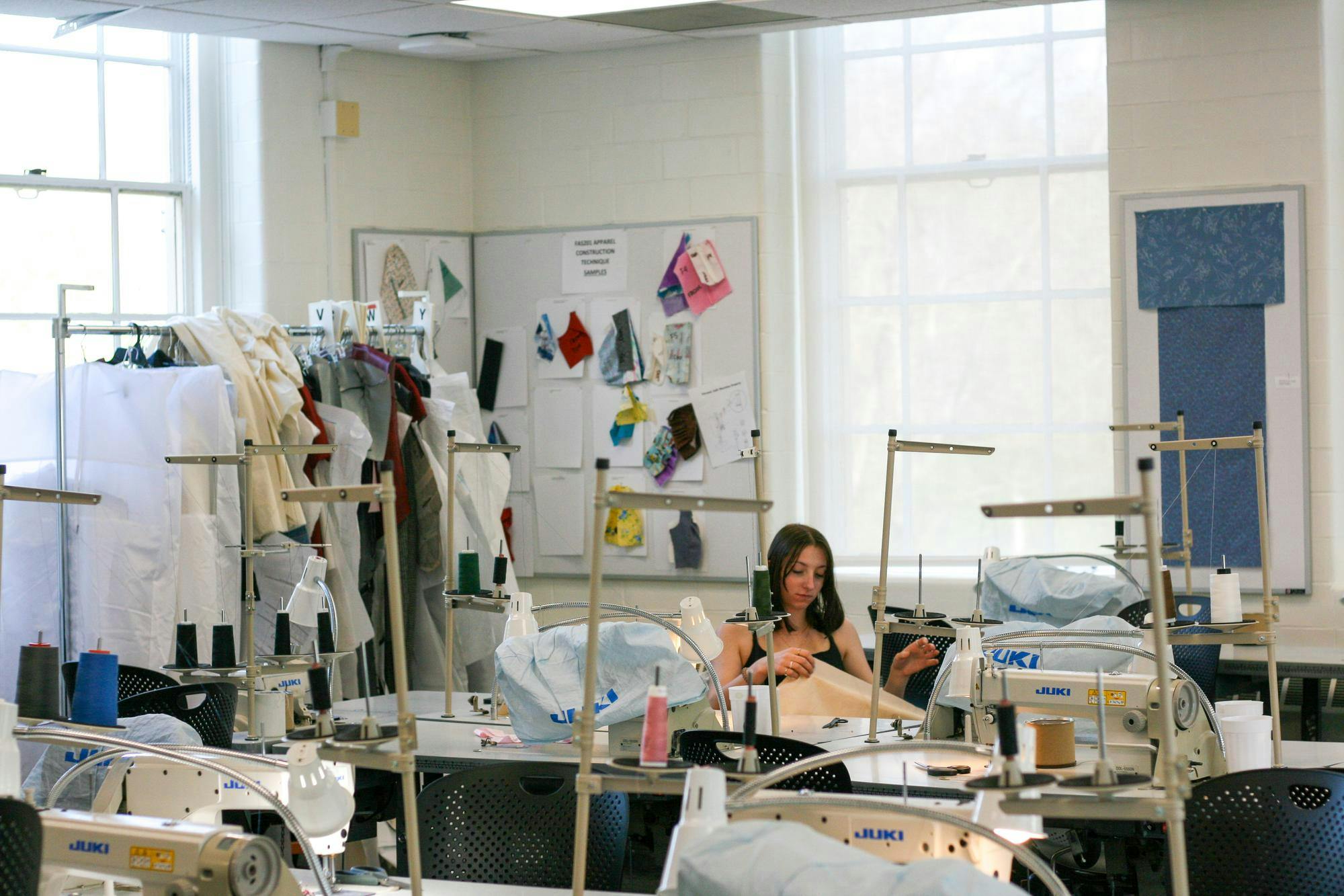 Student working inside fashion design studio in Boyd Hall.