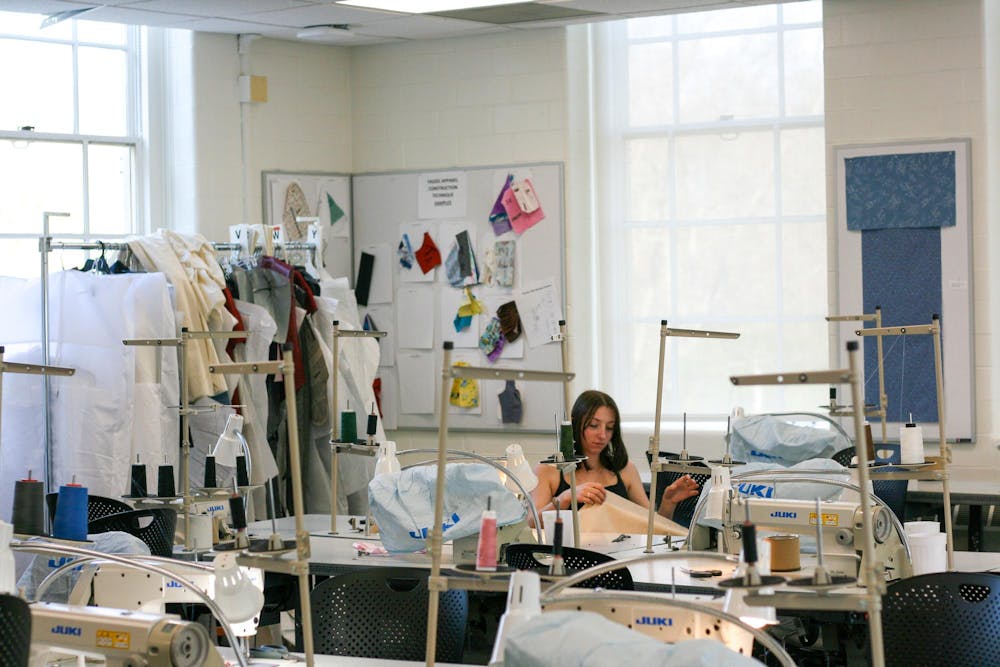 Student working inside fashion design studio in Boyd Hall.