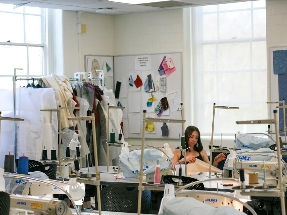 Student working inside fashion design studio in Boyd Hall.
