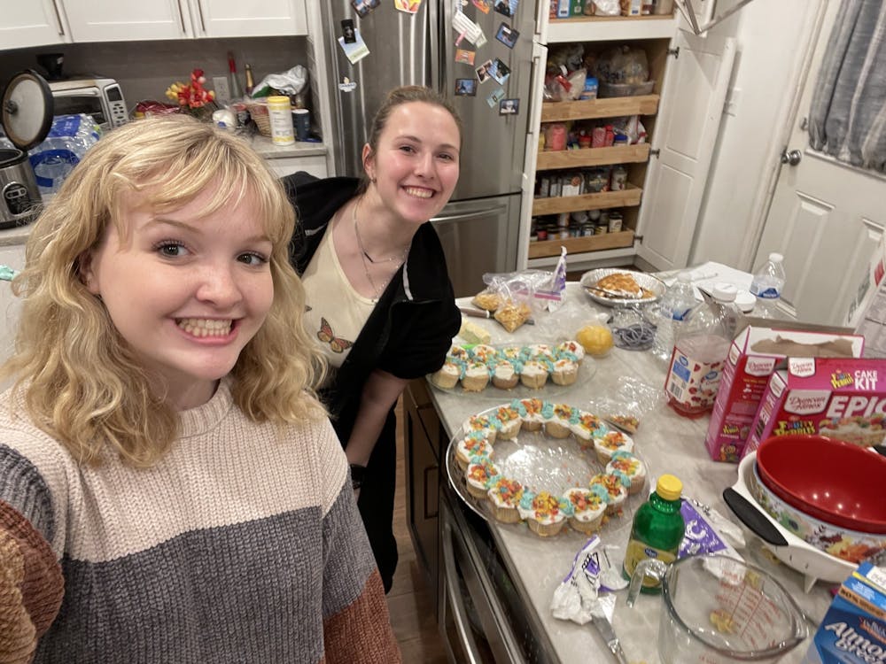<p>Sophomore Meredith Perkins (left) and freshman Kayle Slacksteder (right) prepared multiple dishes, from cupcakes to kugel, at the Chabad dinner on Feb. 24.</p>