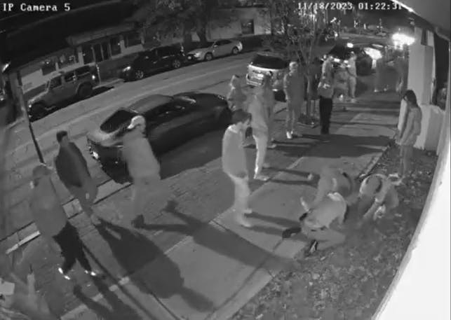Multiple people restrain Miami University football player Devin Johnson outside Brick Street Bar on Nov. 18.