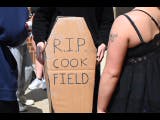 Student stands with cardboard coffin