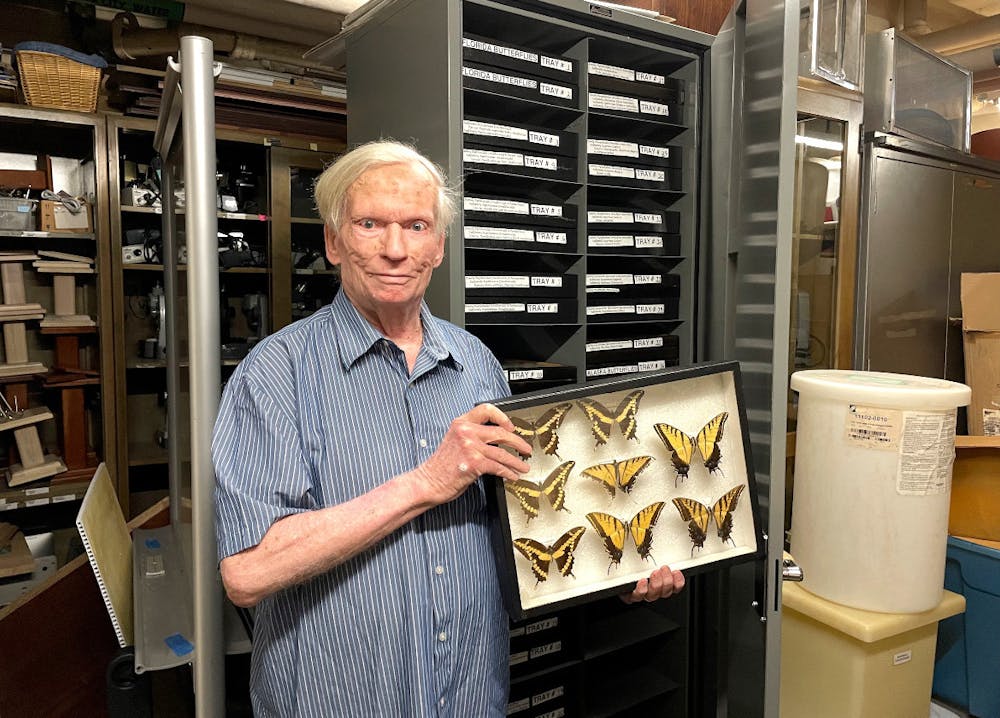 Jack Vaughn holds a display case showing some of his most impressive butterfly specimens.