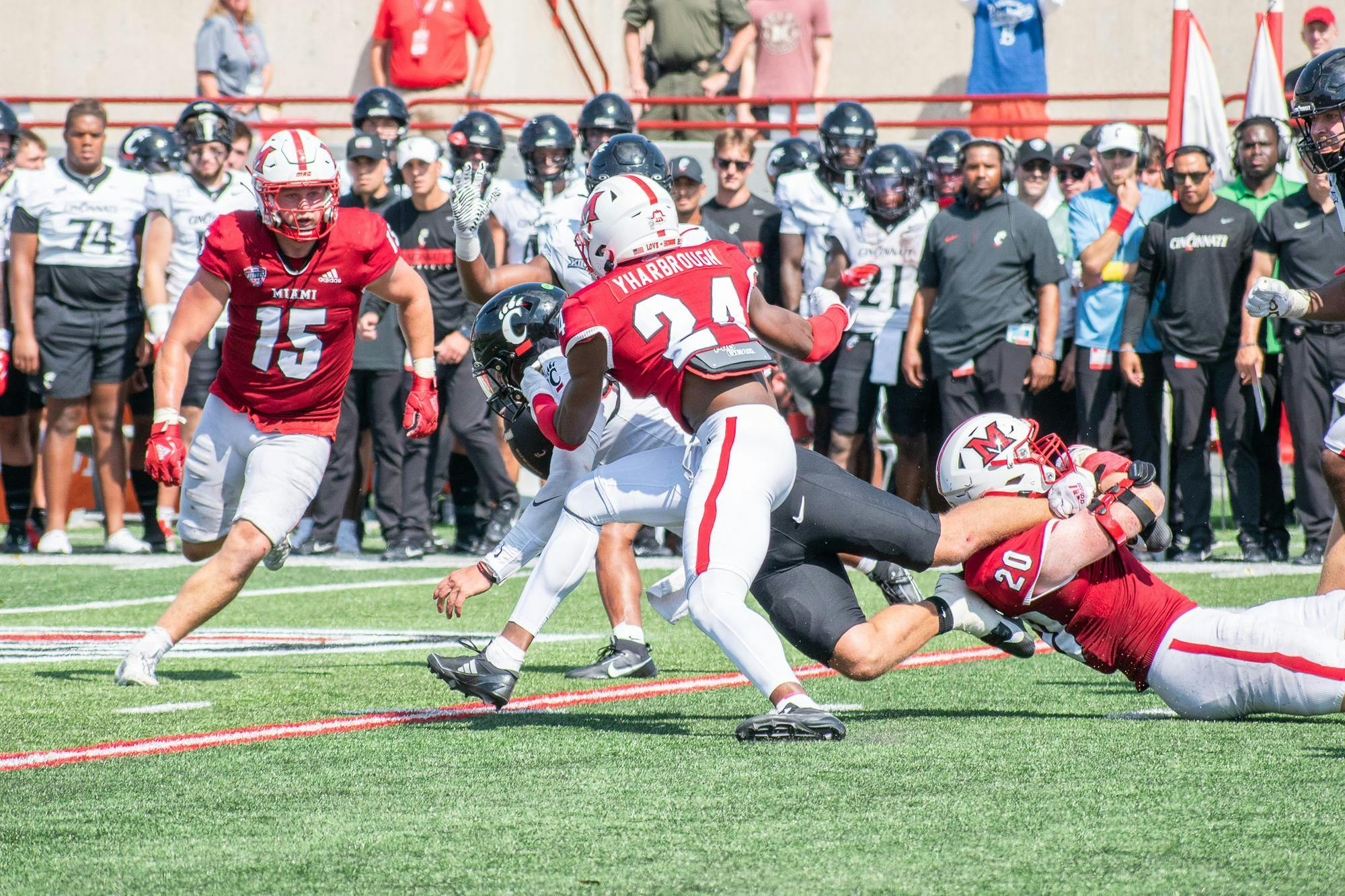 Mychal Yharbrough runs to avoid falling player in game against University of Cincinnati.