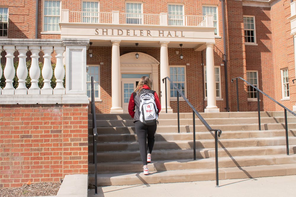 <p>A student-athlete walking into class at Shideler Hall</p>