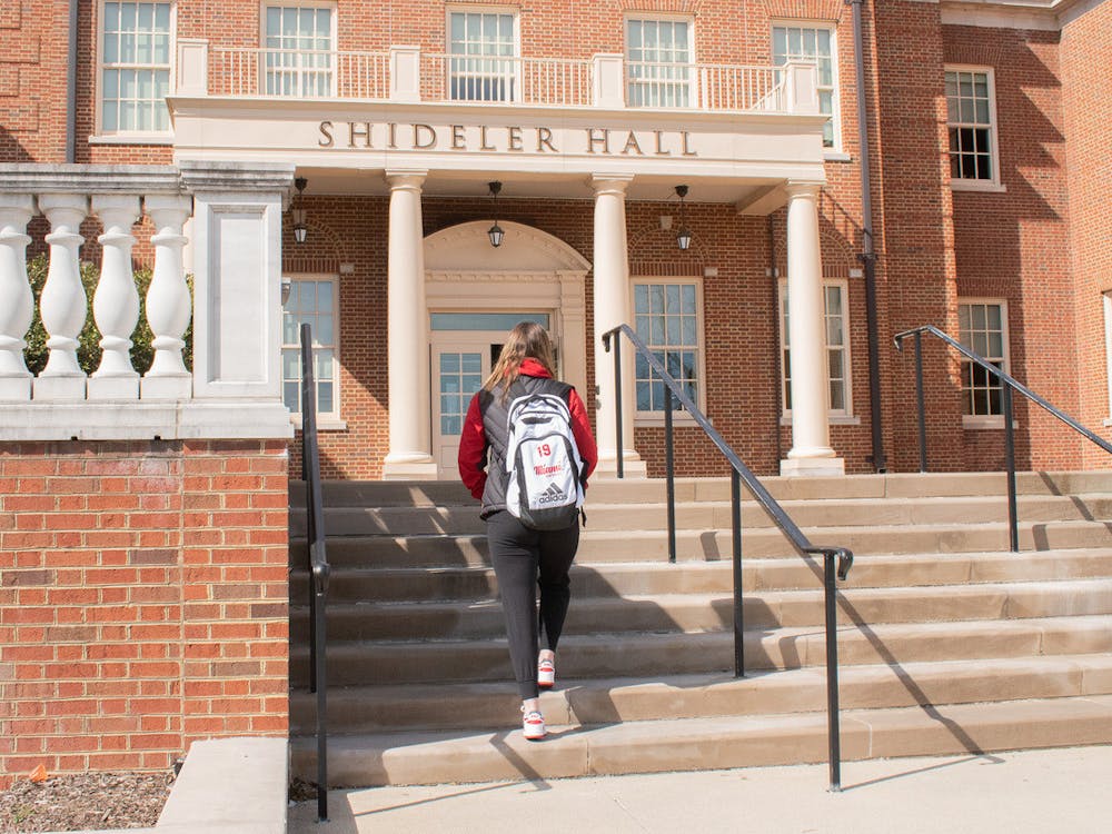 A student-athlete walking into class at Shideler Hall