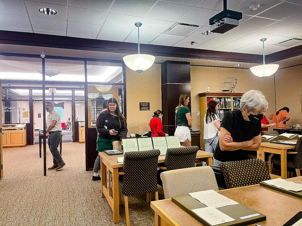 Viewers walk around King Library to look at the Wells hall time capsule.