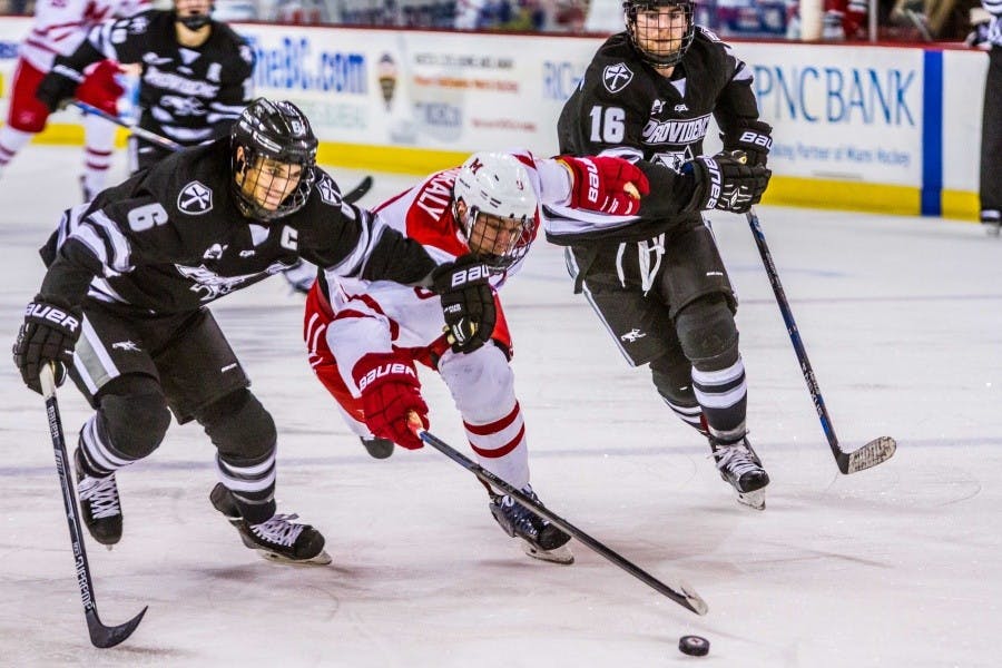 Junior defenseman Colin Sullivan fights for the puck against Providence.