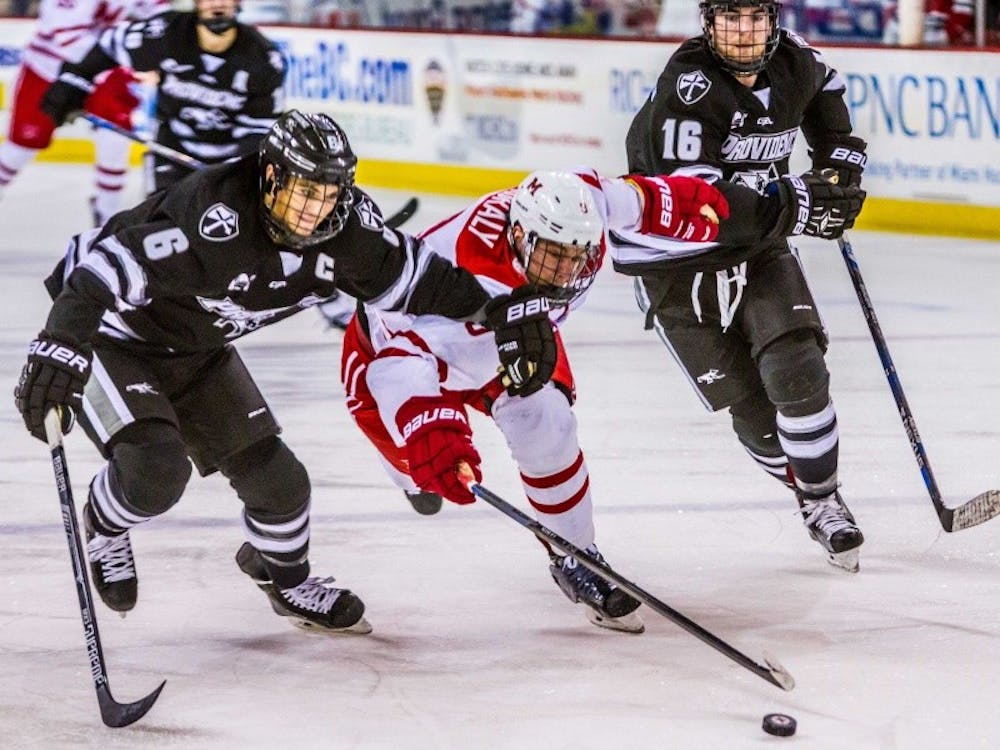 Junior defenseman Colin Sullivan fights for the puck against Providence.
