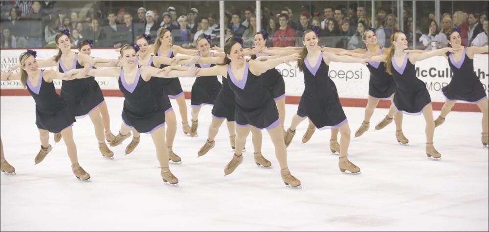 Miami’s collegiate skating team performs for hockey fans during an intermission at the Goggin Ice Center. 