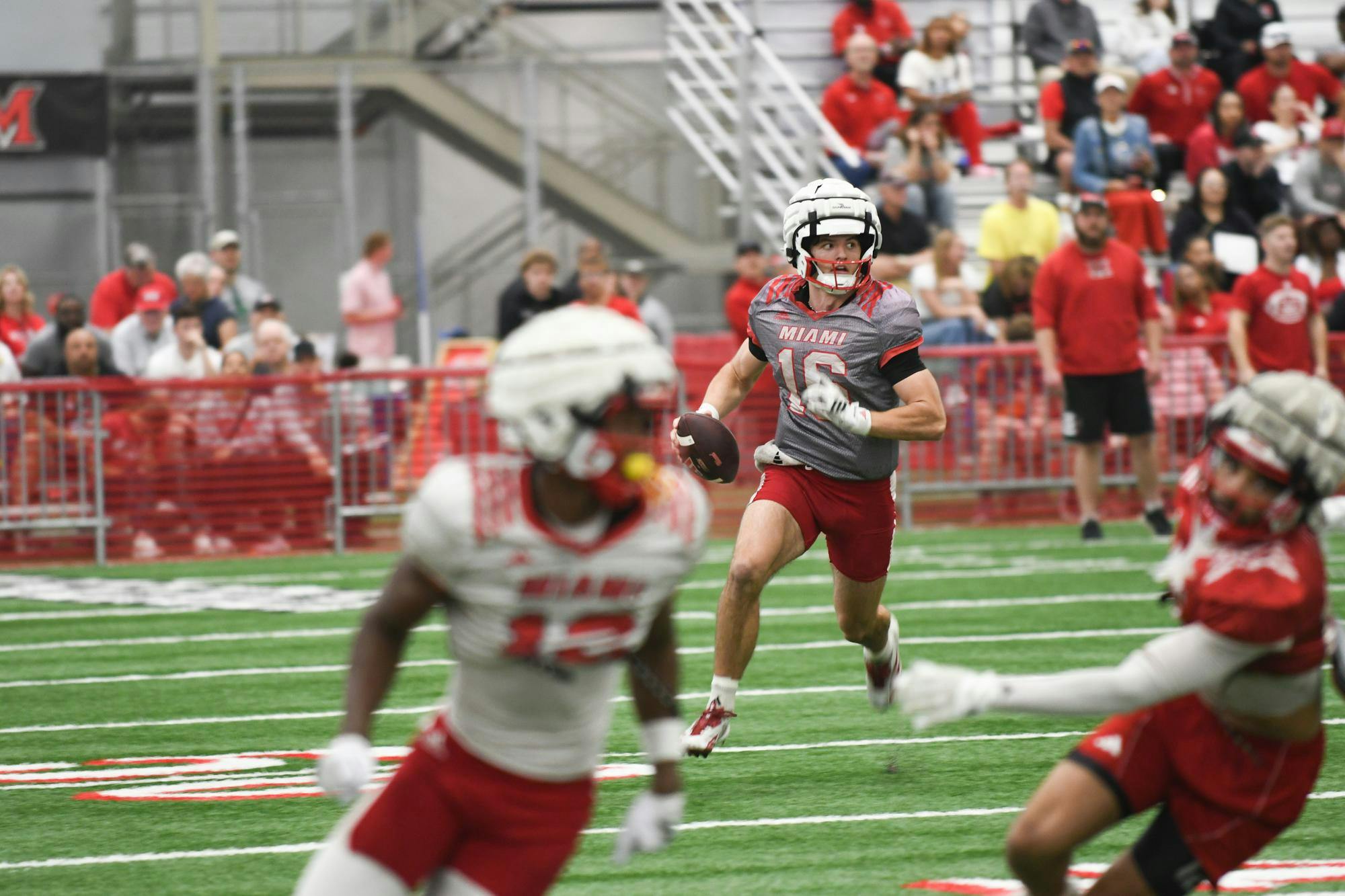 Quarterback David McComb scampers through the defense during the spring game on April 25. 