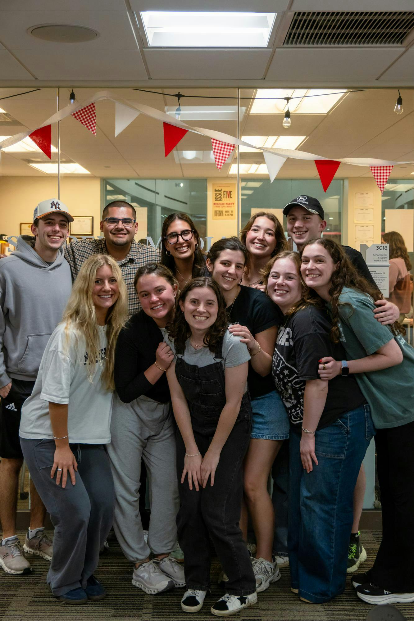 Caitlin Dominski (middle, overalls) surrounded by friends at The Student.