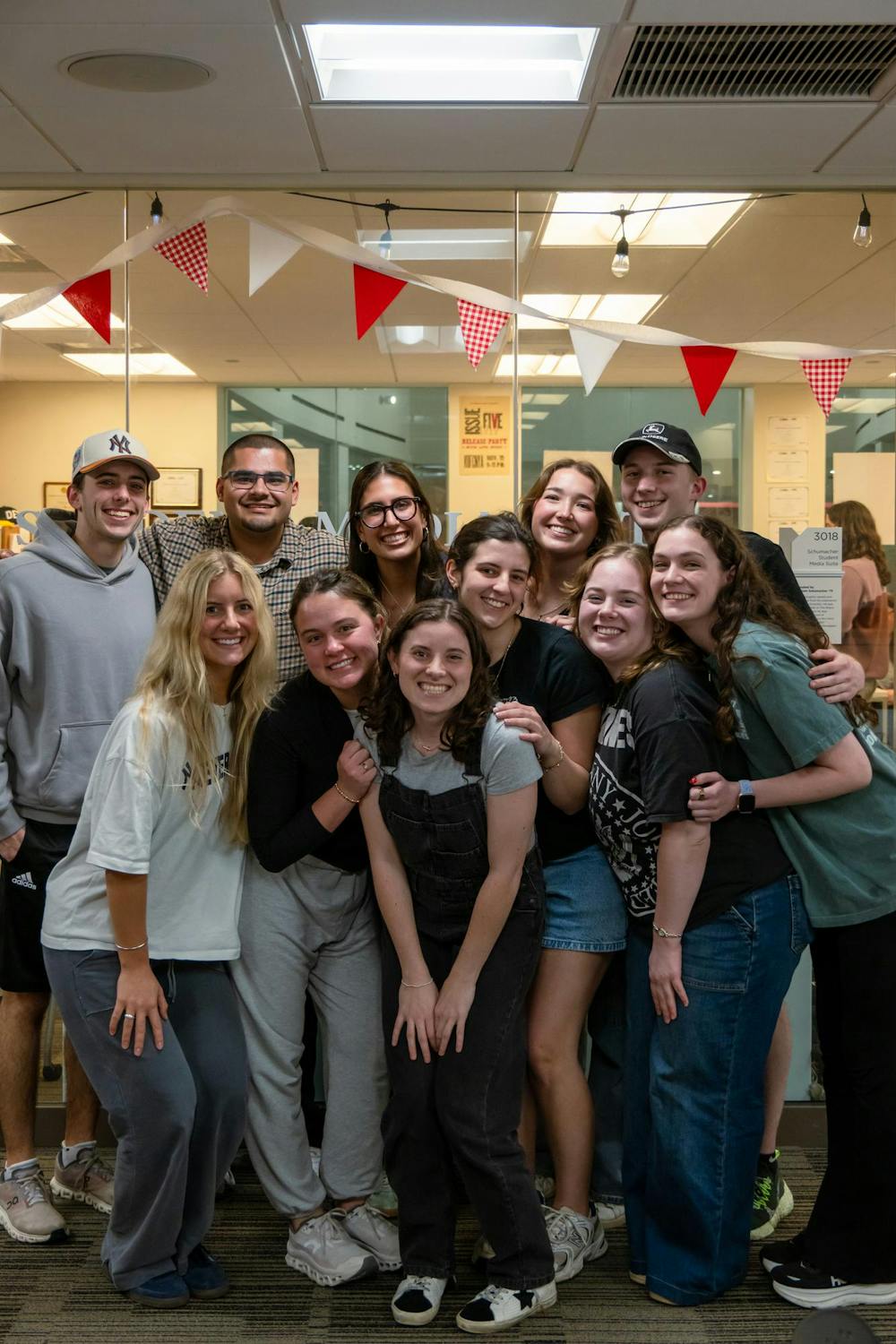 Caitlin Dominski (middle, overalls) surrounded by friends at The Student.