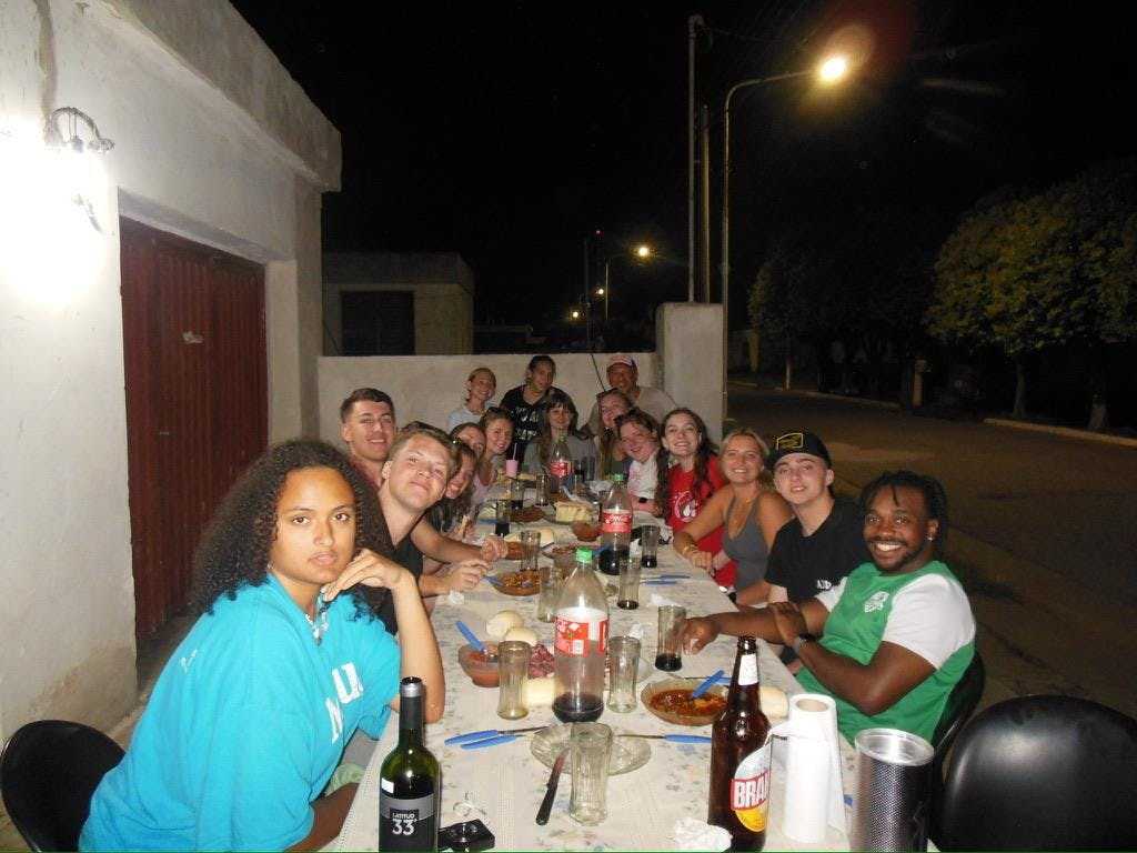 Miami students gather around a table for a meal in Colonia Almada, Argentina, during their winter study abroad. Photo provided by Elisa Rosenthal