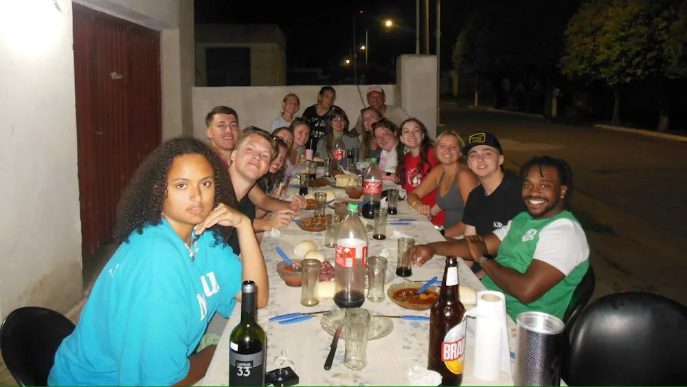 Miami students gather around a table for a meal in Colonia Almada, Argentina, during their winter study abroad. Photo provided by Elisa Rosenthal