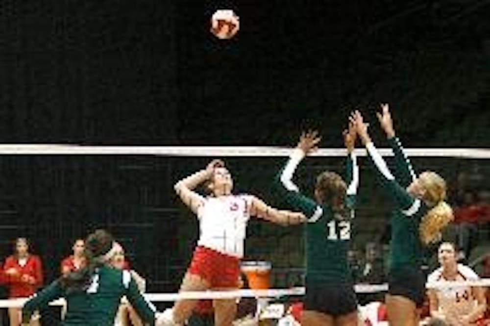 RedHawk middle hitter Carli Reihman takes on two Ohio blockers during Saturday night's match. Ohio was able to avenge its Sept. 28 loss to Miami, knocking off the 'Hawks 3-1. MU trails OU by two games in the MAC standings.