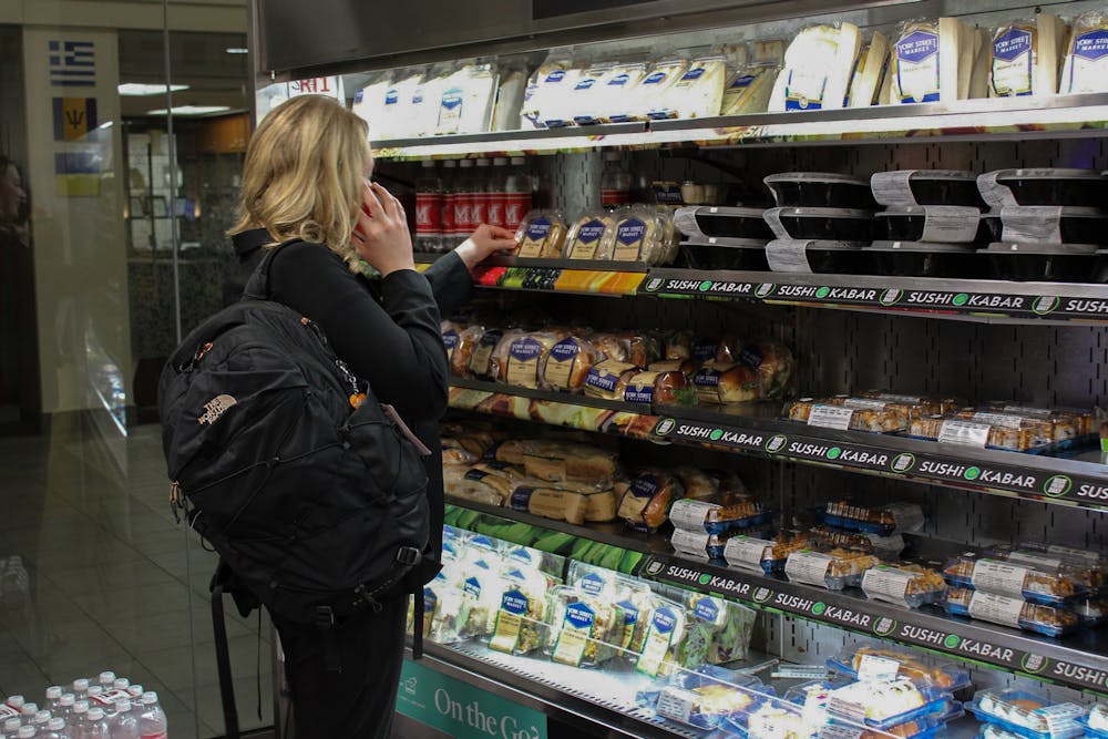 <p>A student browses the to-go meal options available in Emporium, Armstrong Student Center’s market.<br/><br/></p>