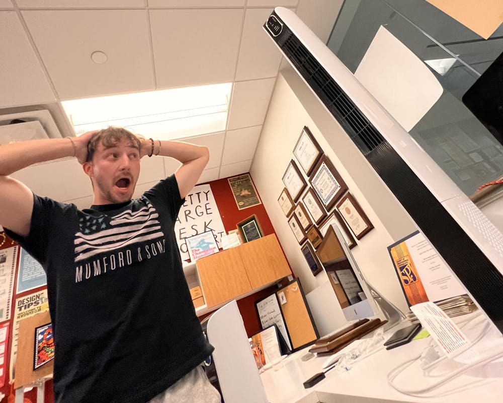 Jake Ruffer stands dumbfounded that the fan found its way atop our EIC’s desk. It should NOT be there.