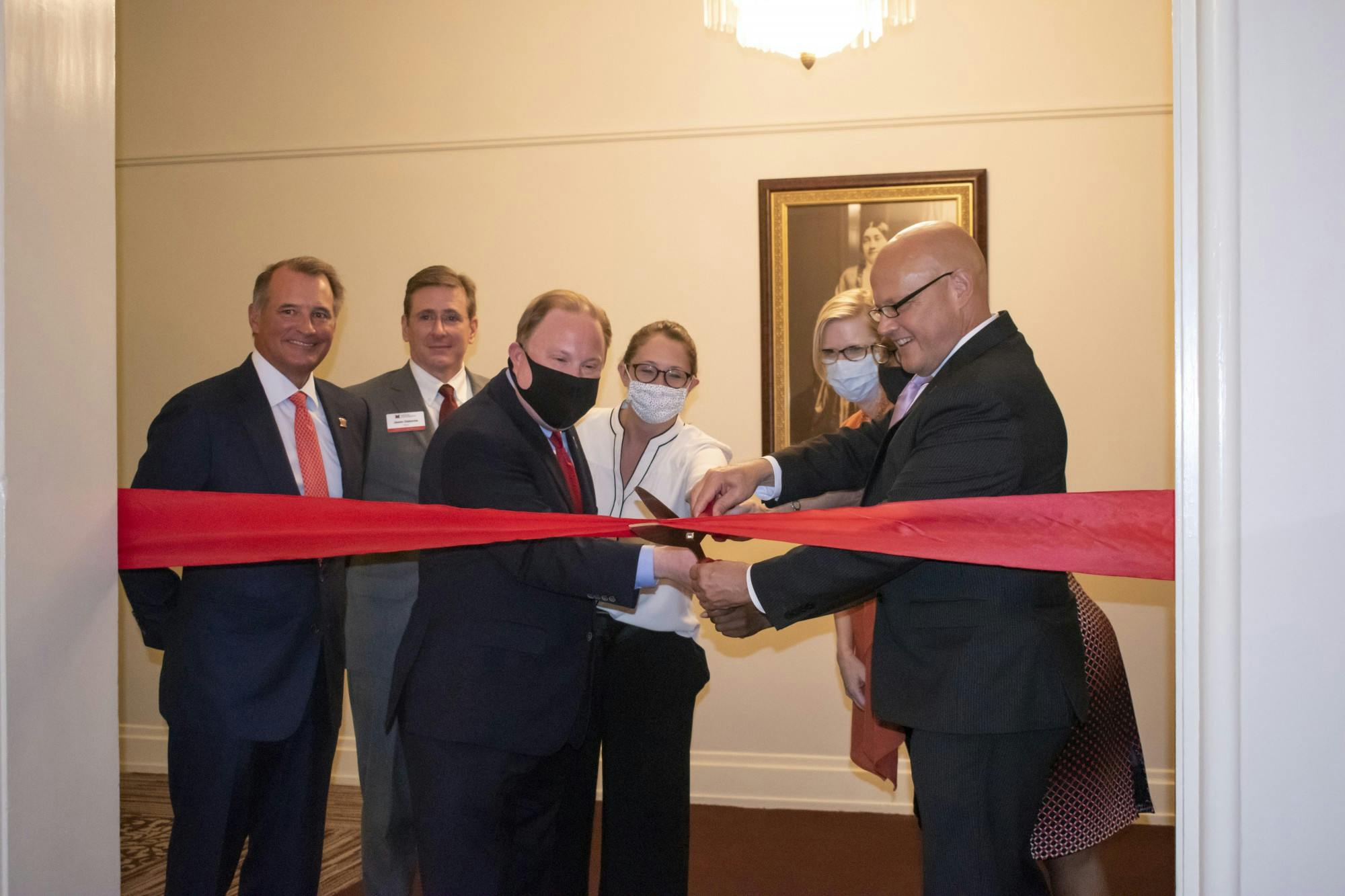 Miami University President Greg Crawford helps cut the ceremonial ribbon inside Peabody Hall on Thursday, Aug. 26, symbolizing the beginning of Miami&#x27;s new Honors College.
