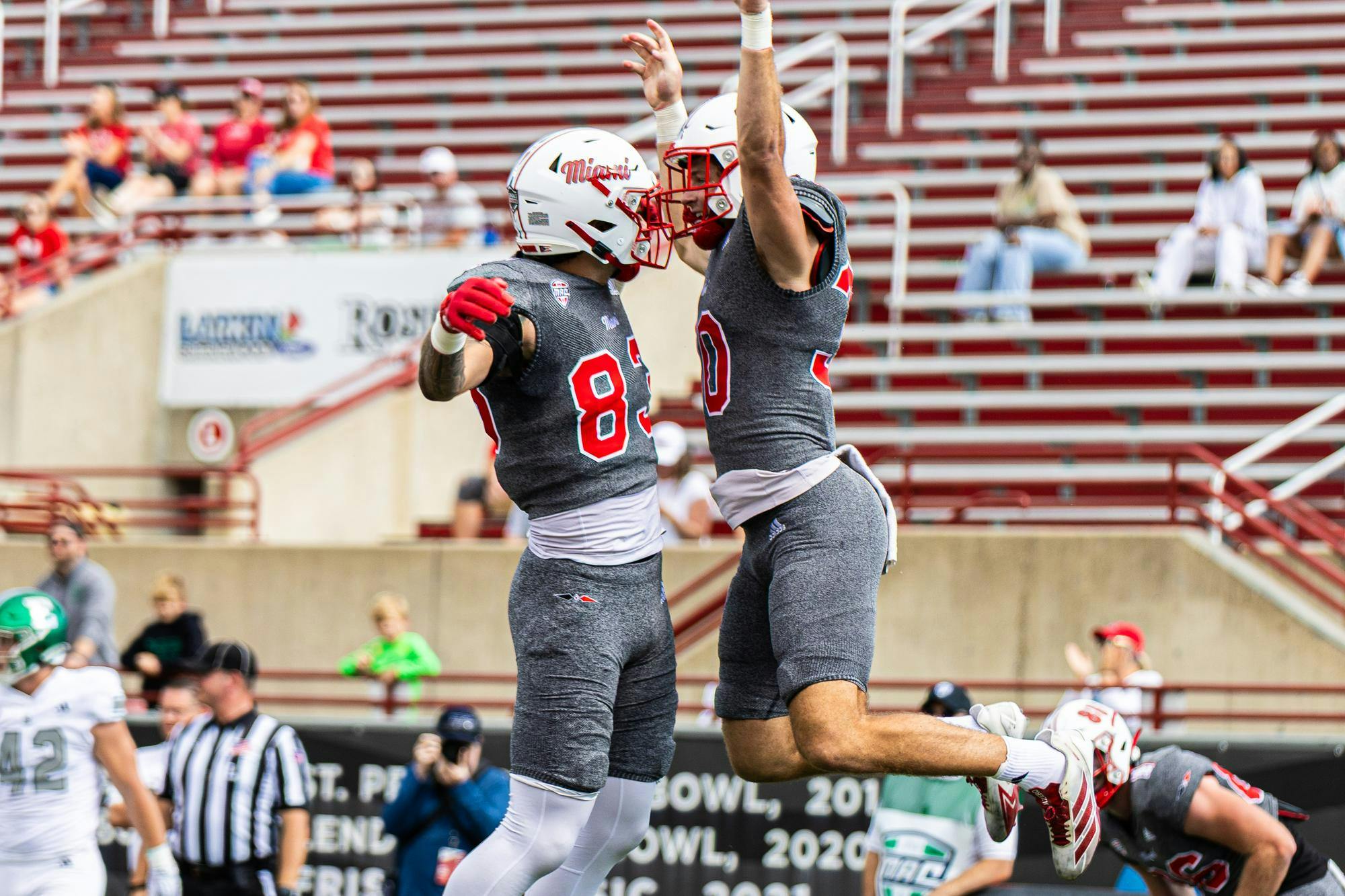 Redshirt freshman running back Josh Ringer (right) celebrates a touchdown with redshirt freshman tight end Eric Karner on Oct. 18 against Eastern Michigan at Yager Stadium