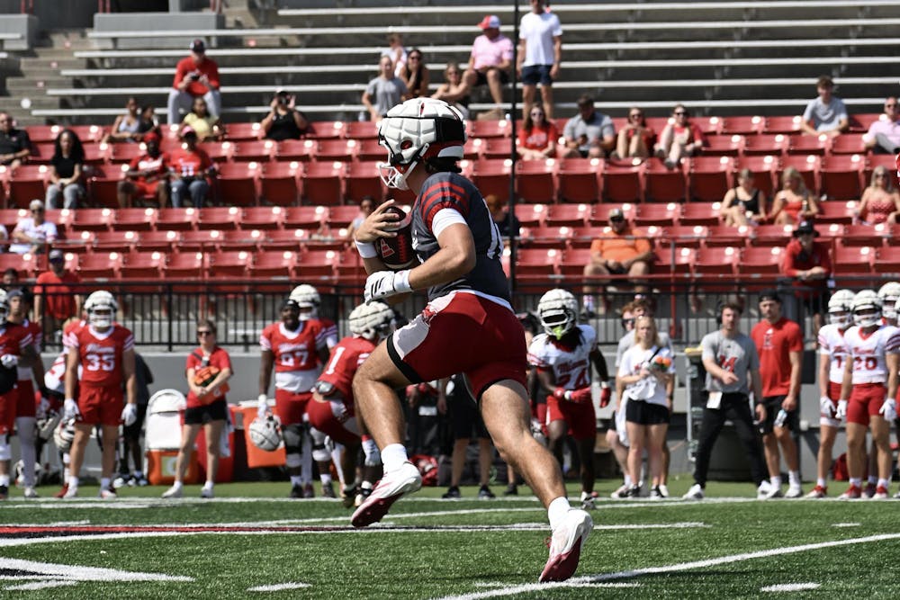 Quarterback David McComb tucks the ball for a scramble during practice.