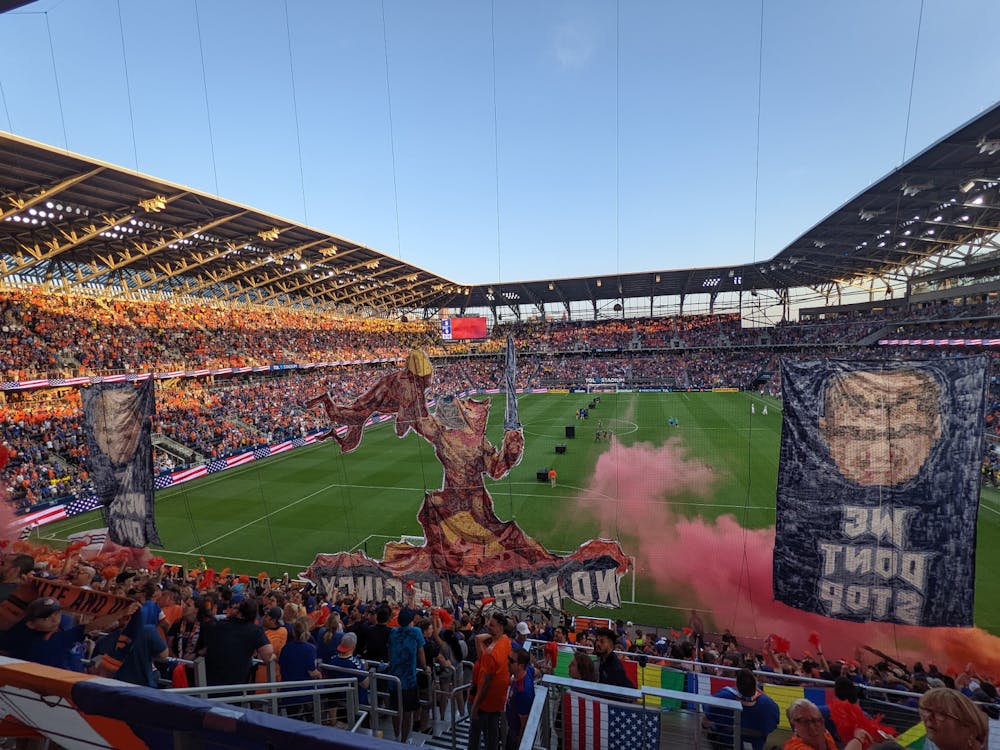 <p>Caption: FC Cincinnati supporters watch on as a tifo is raised before the Hell is Real derby game against Columbus.</p>