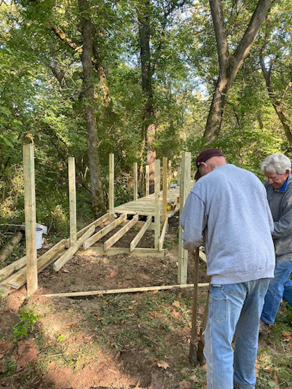 Volunteers work to add to the boardwalk in Ruder Preserve.