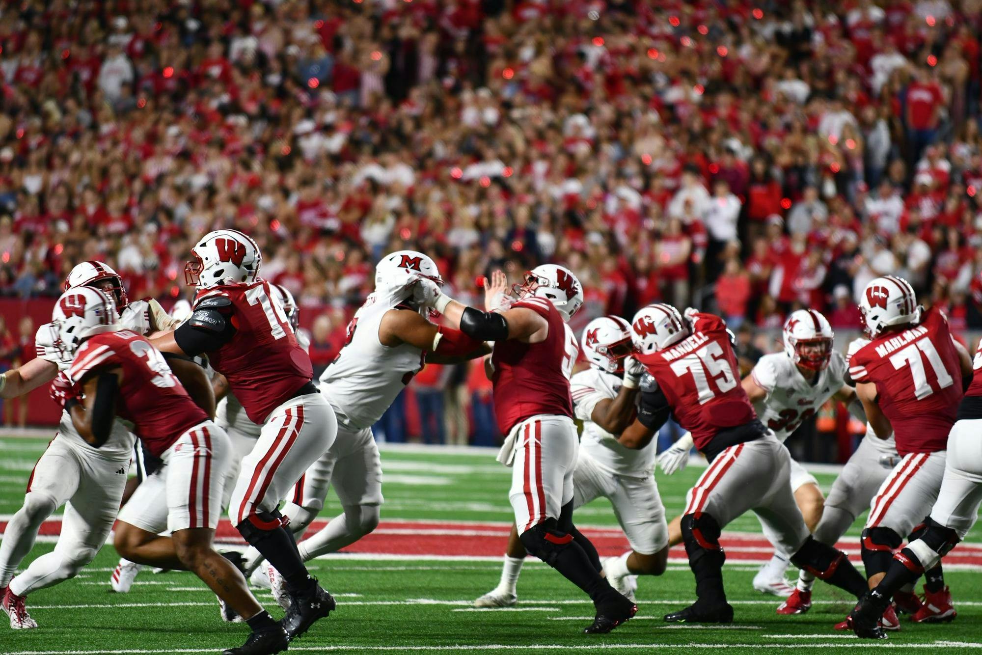 Miami’s defense tries to break through Wisconsin’s offensive line during the third quarter at Camp Randall Stadium on Aug. 29