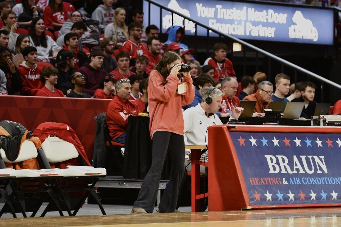 Elisa Rosenthal takes photographs courtside at Millett Hall during the men's basketball game against the University of Massachusetts on Jan. 27, 2026.  
